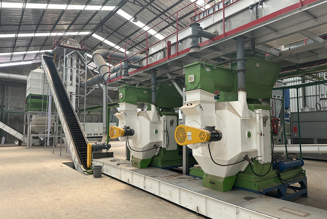 Kingwood ring die pellet mill components including ring die, roller shells, and spare parts laid out for inspection
