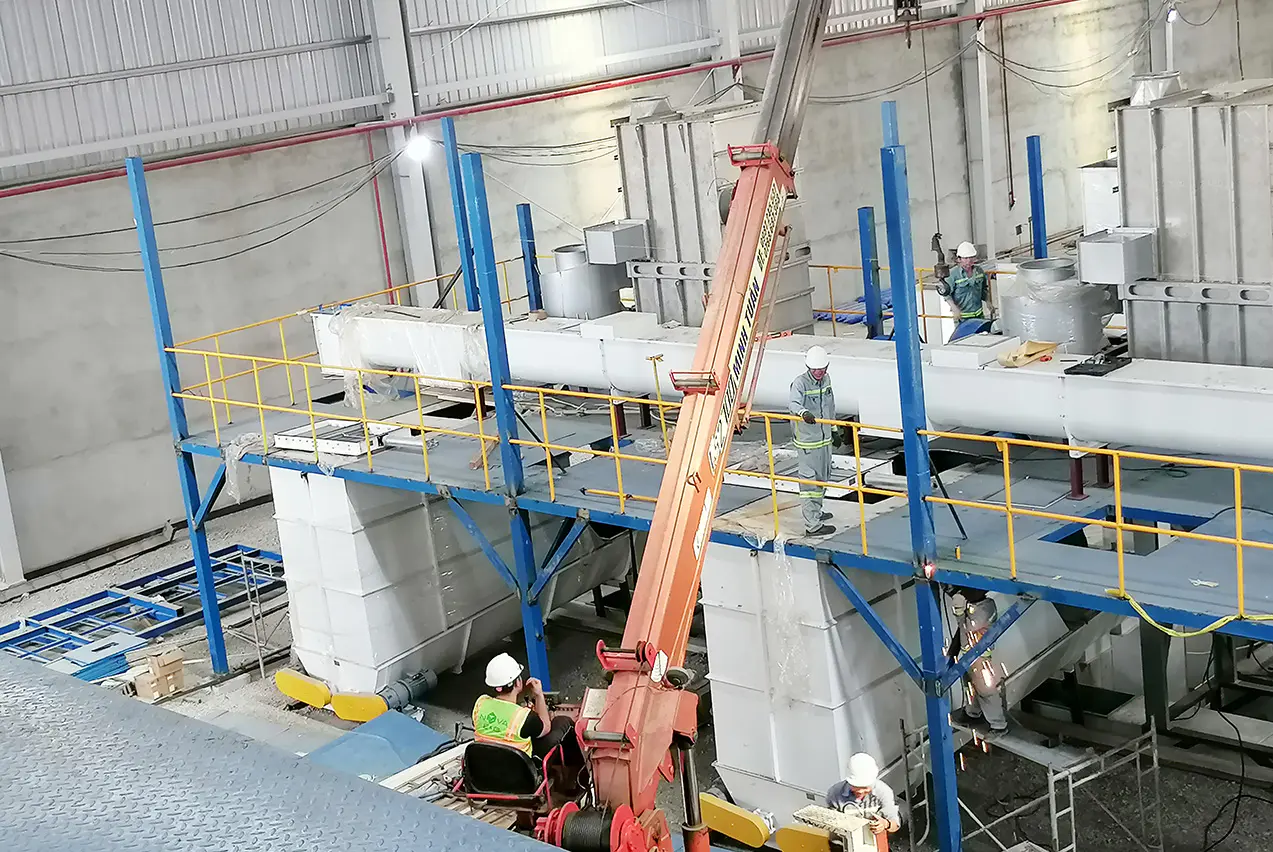 Enclosed screw conveyor and dust extraction system in a Vietnamese biomass pellet production workshop